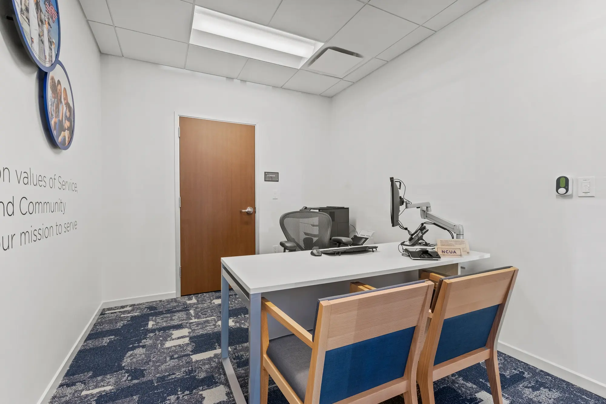 Private member consultation office with blue branded globe wall, "A lifetime of guidance and support" text, desk and guest chairs
