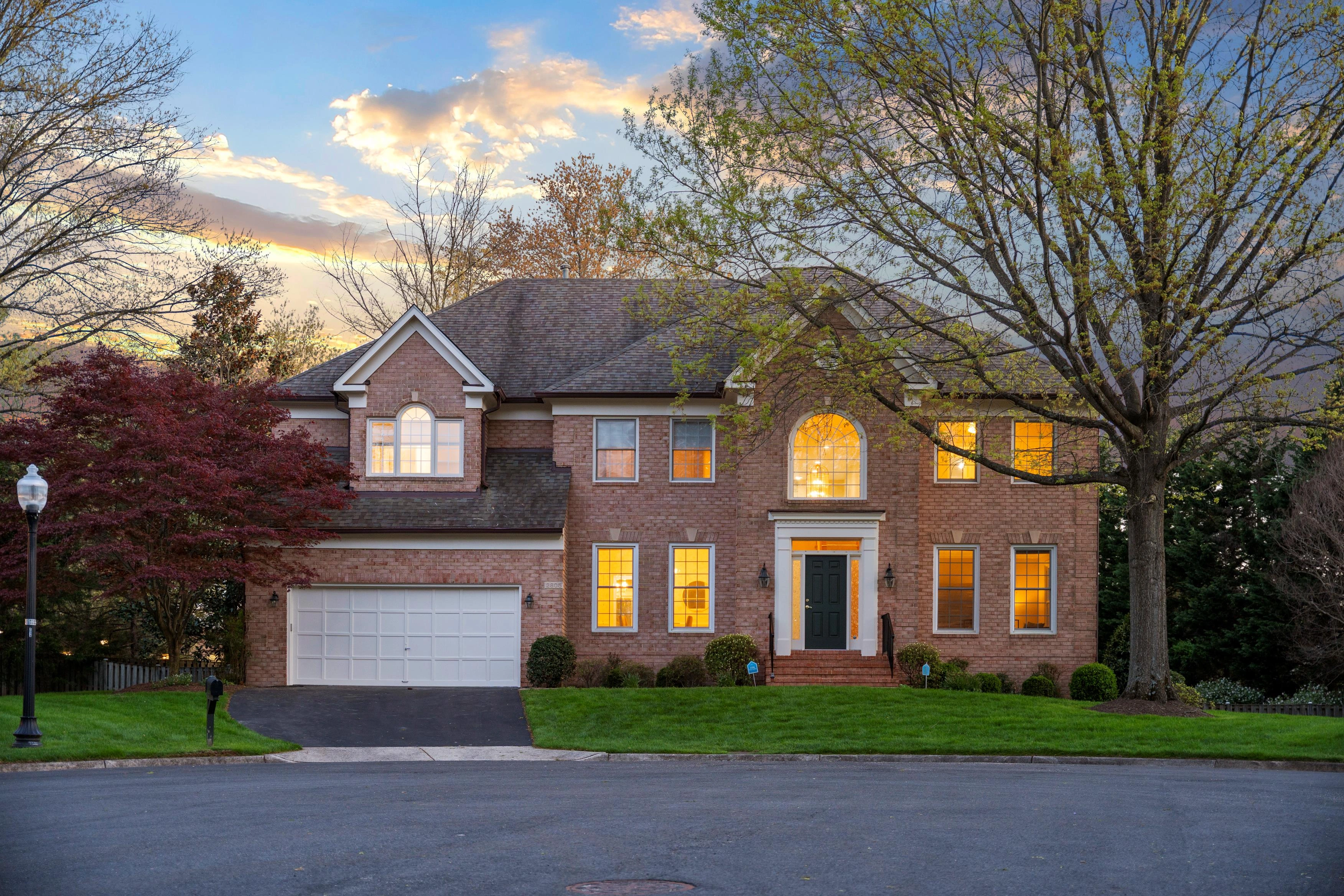 Professional luxury real estate photography of a grand estate home with landscaped grounds in Oakton, Virginia by Umedia