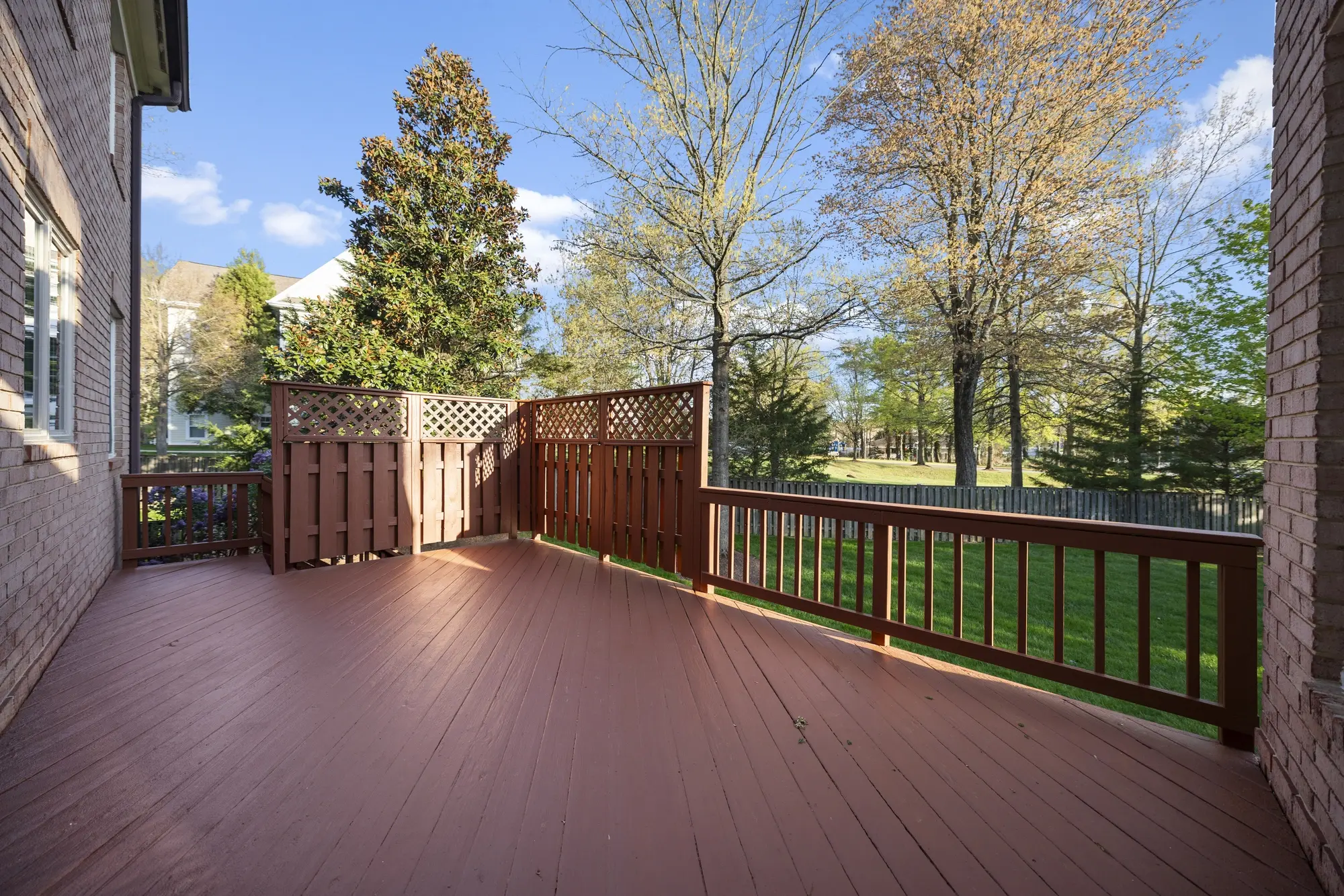 Spacious wooden deck overlooking mature trees