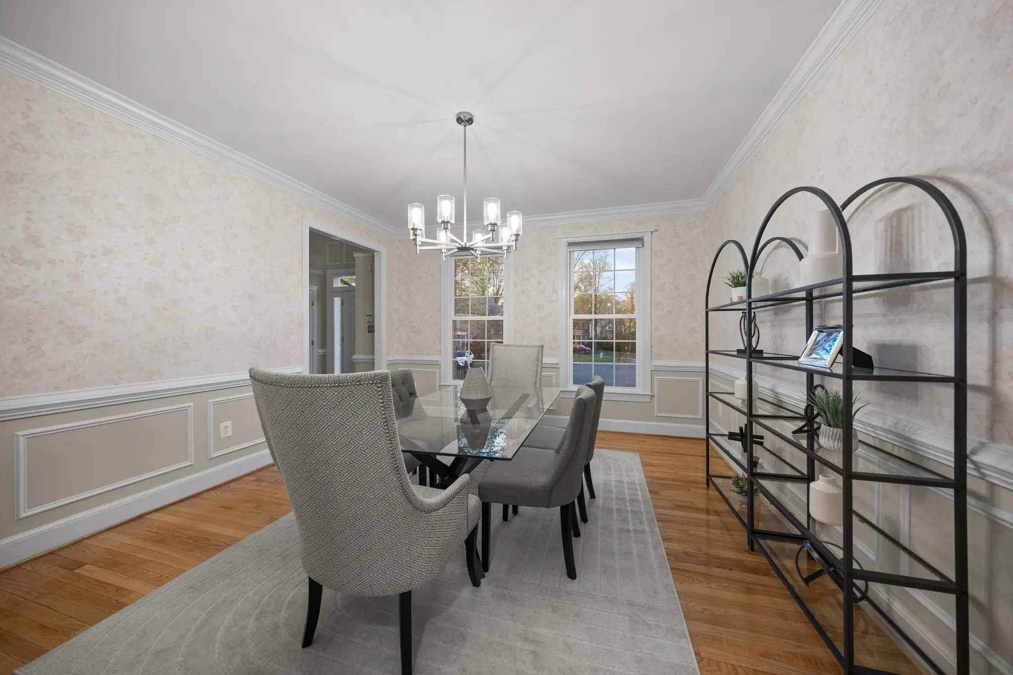 Elegant dining room with glass table and modern chandelier