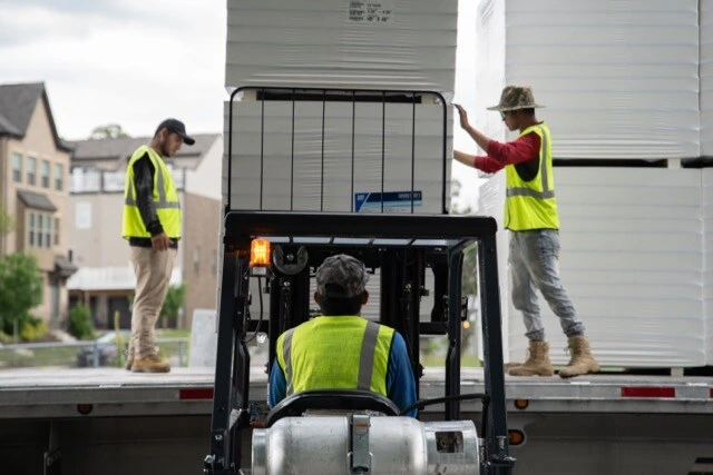 Construction scaffolding photography — workers on commercial building site