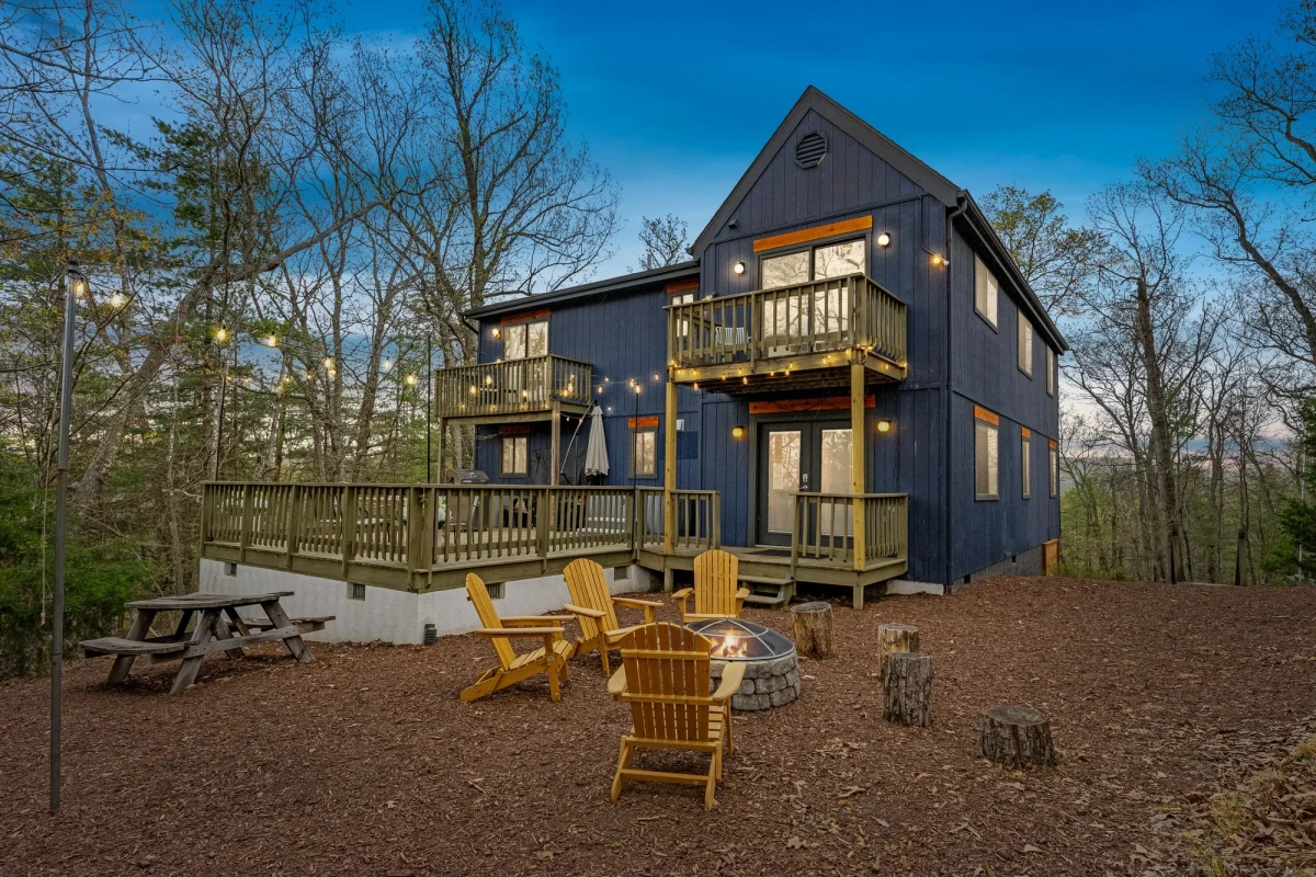 Basye, VA mountain house at dusk with warm lights glowing